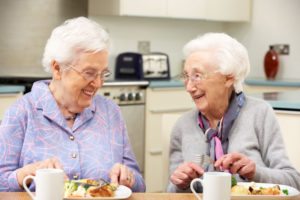 two elder women happily eating
