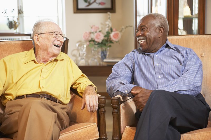 two elder men laughing together