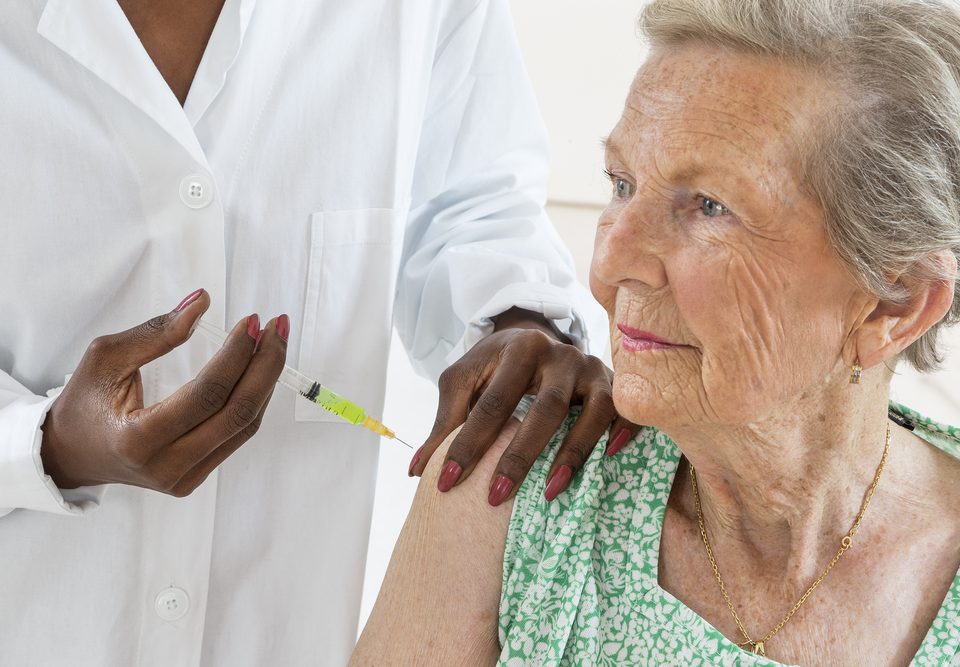 elder woman getting a shot
